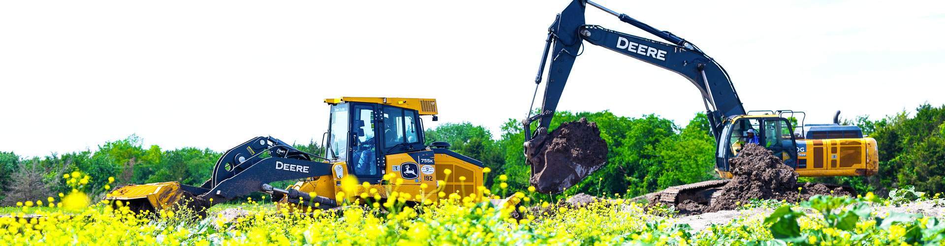 Dozer and excavator moving dirt during site preparation work in a North Texas field